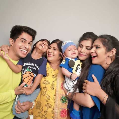 Aadil Khan with his mother and sisters
